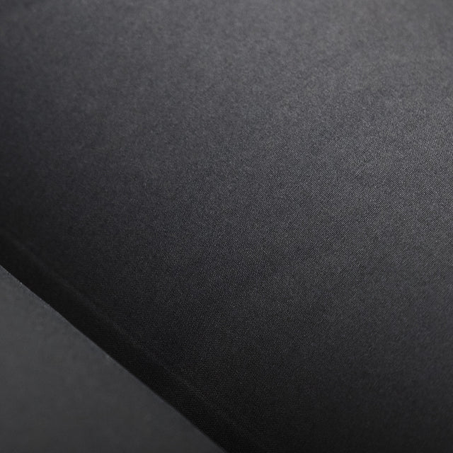Close-up of Zenbivy mattress surface made with smooth, soft 20D polyester taffeta fabric. The black material appears lightweight and sleek, ideal for backcountry use.