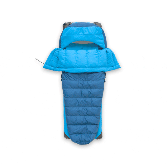 Bright blue Zenbivy quilt and sheet system shown separately on a white background. The quilt is spread open, and the sheet covers a mattress with a built-in hood. Text on the right describes how the Zenbivy bed differs from mummy bags and traditional quilts.