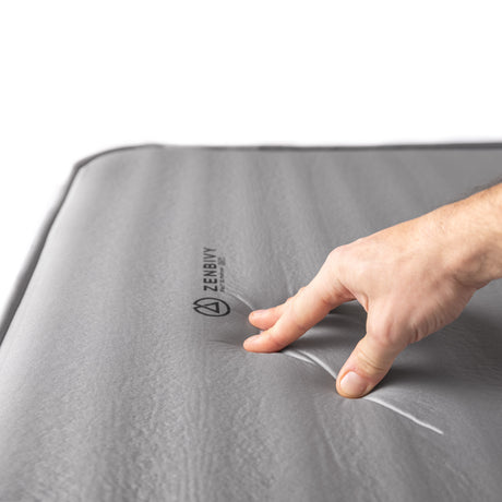 Close-up view of Zenbivy Flex™ mattress surface highlighting the exclusive 4-way stretch top fabric. The fabric forms soft, rounded indentations, showing its flexibility and ability to conform to the sleeper’s shape.