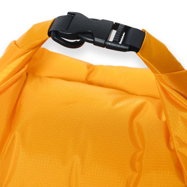 Top view of a bright orange Zenbivy Dry Sack with a black roll-top closure buckle.