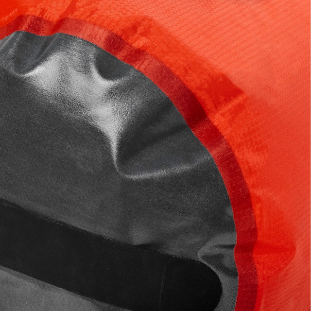 Close-up of red fabric seam with black patch, showing Zenbivy Dry Sack’s fully welded seam construction.