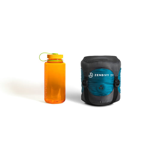 Zenbivy Ultralight Bed compressed into dry sack next to Nalgene bottle, illustrating compact, lightweight design ideal for backpackers minimizing bulk and weight.