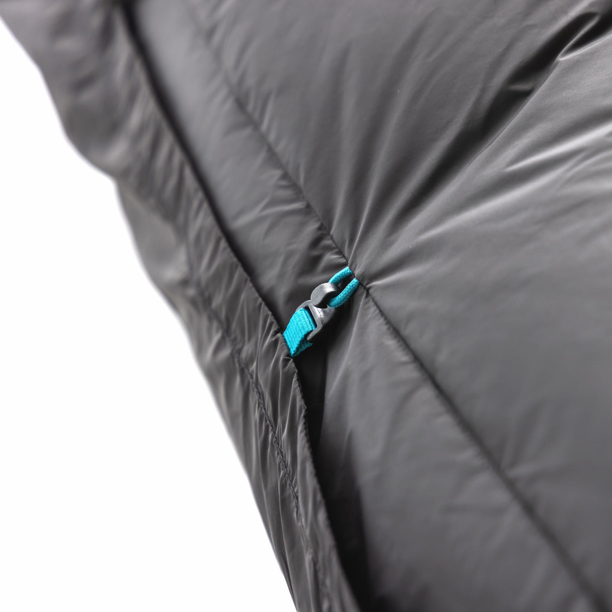 Close-up of Zenbivy quilt’s lightweight clip attachments, ensuring a secure, draft-free connection to the sleep system while maintaining minimal weight.