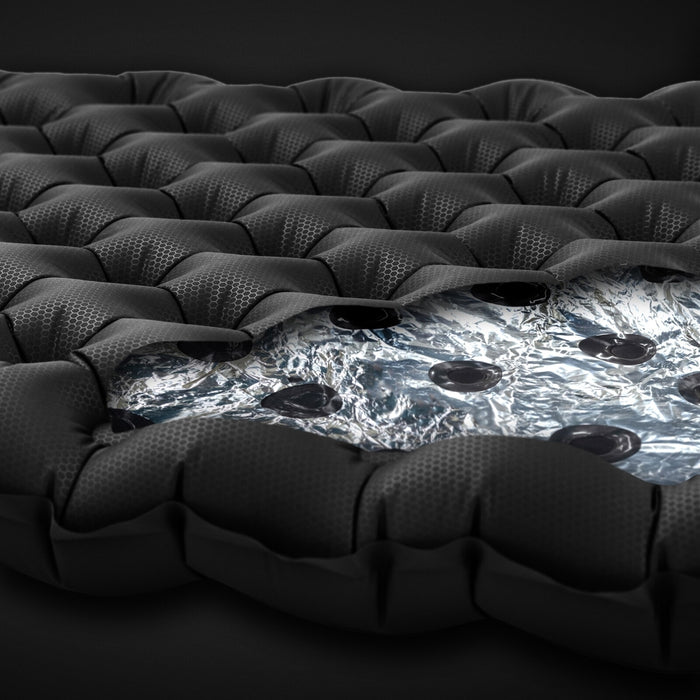 Cross-sectional view of Zenbivy mattress featuring reflective Mylar layers. The shiny silver Mylar floats quietly within the baffles to reflect heat and improve insulation performance.