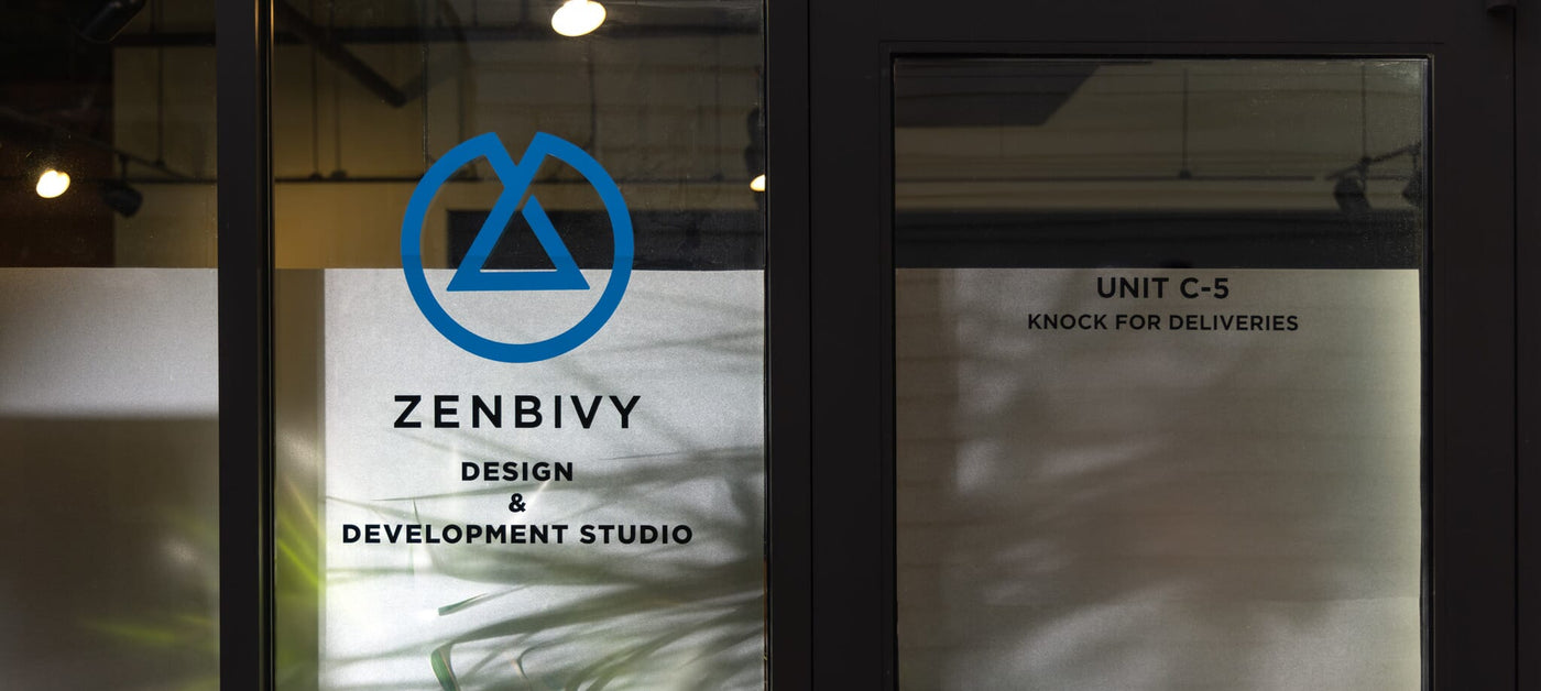 Glass door with Zenbivy logo and text at a design and development studio.