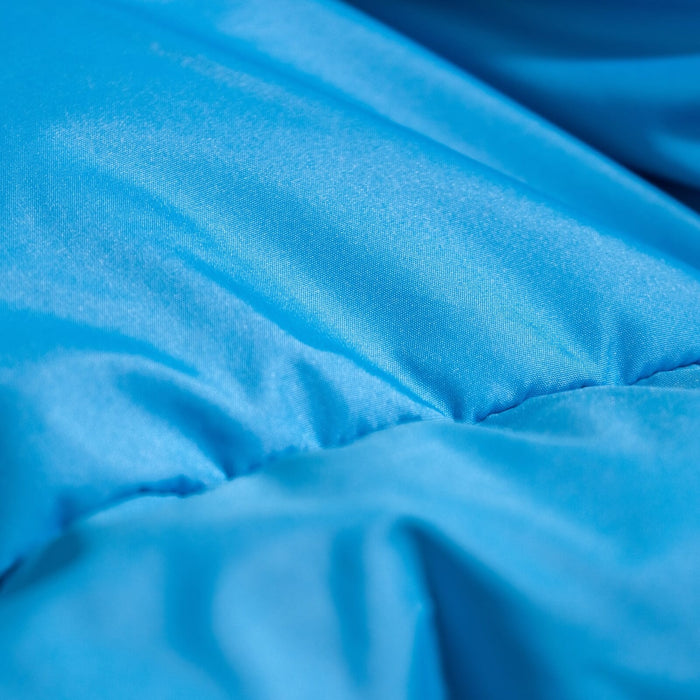 Close-up of soft, blue 50D Polyester Pongee fabric used in Zenbivy sleeping bags, highlighting its smooth, luxurious texture designed for camping comfort.