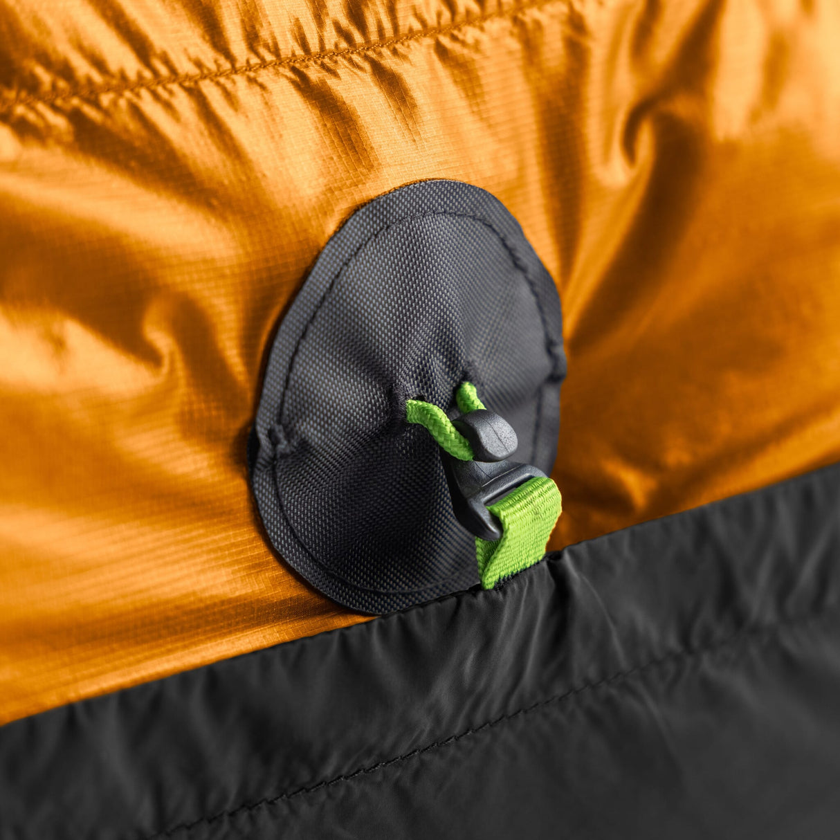 Close-up of a Zenbivy Conversion Patch on an orange quilt showing how to convert any quilt to work with a Zenbivy sheet.