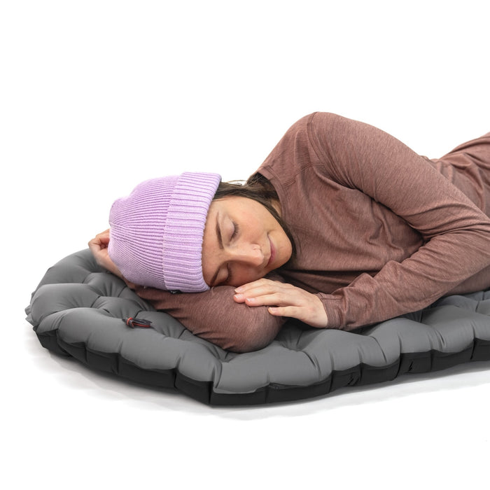Close-up view of Zenbivy Flex™ mattress surface highlighting the exclusive 4-way stretch top fabric. The fabric forms soft, rounded indentations, showing its flexibility and ability to conform to the sleeper’s shape.