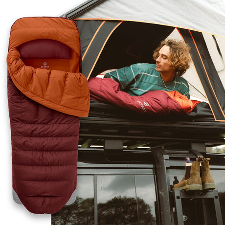 Orange and red sleeping bag next to a person inside a vehicle with a tent setup.