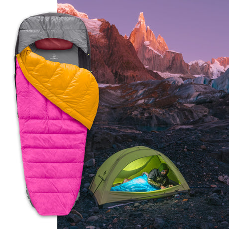 Ultralight Zenbivy sleeping bag system with gray and white quilt, displayed at high-altitude campsite by glacial lake and rocky cliffs.