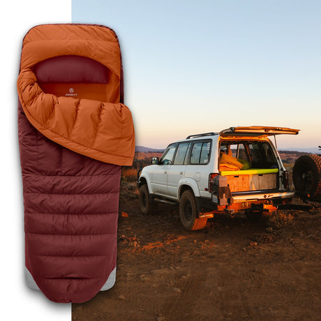 Zenbivy ZipBed Overland system in burnt orange and maroon, showcased with overlanding vehicle at remote campsite during sunset.