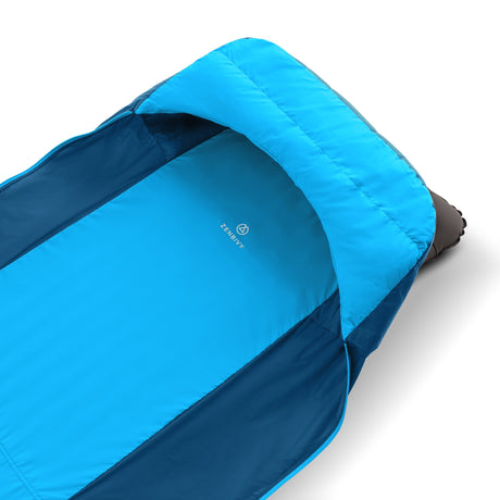 Close-up of Zenbivy sheet with integrated insulated hood in light blue and navy, designed to securely hold a mattress and keep campers warm.
